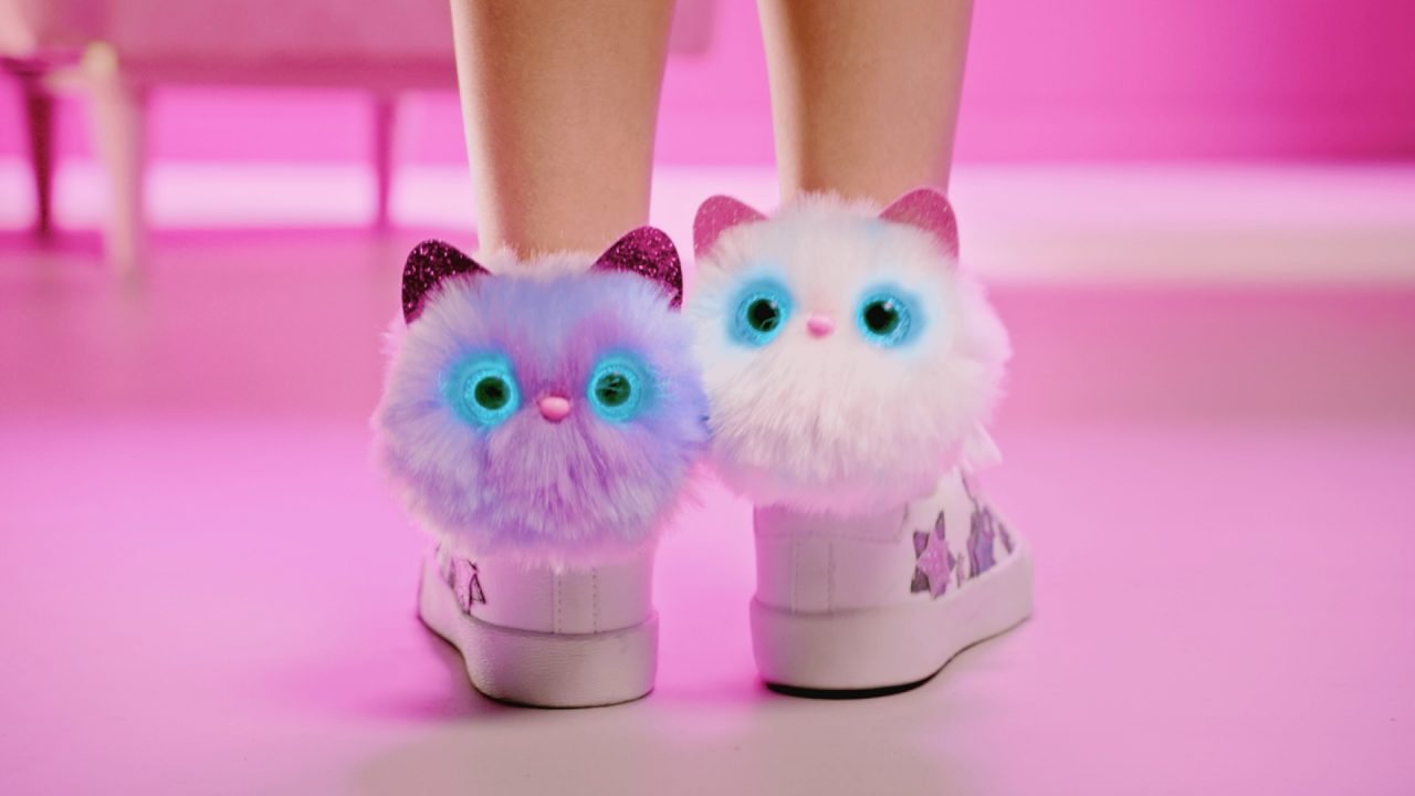 Two Pomsies wrapped around each leg